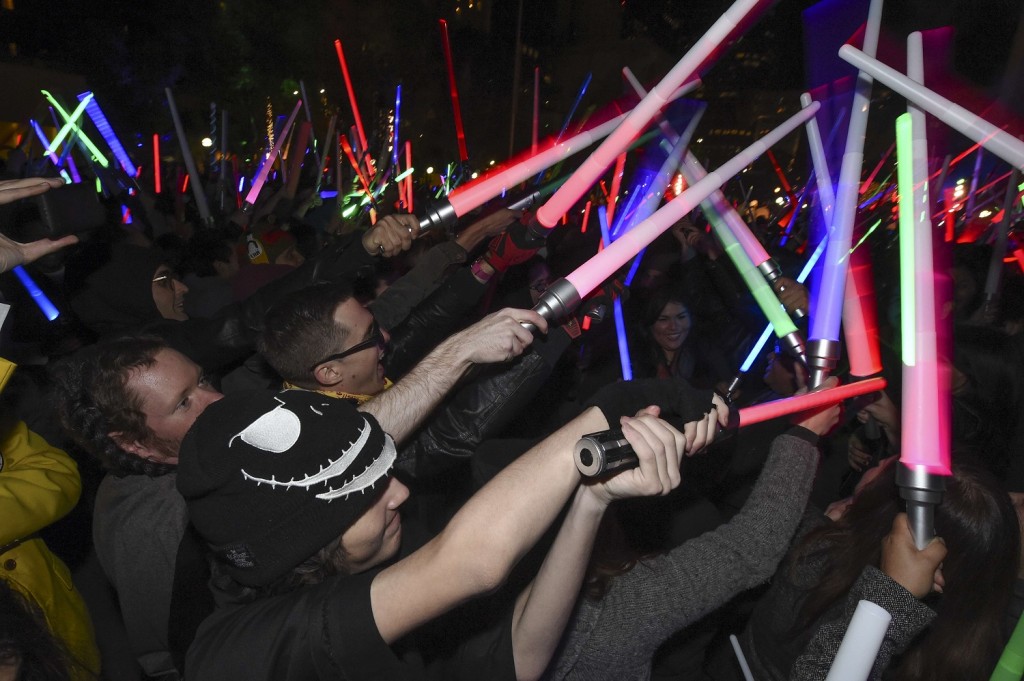Star Wars fans raise their lightsabers during Lightsaber Battle LA in Pershing Square in downtown Los Angeles, California on December 18, 2015. "Star Wars: The Force Awakens" smashed the opening night record in the United States and Canada positioning itself to become one of the biggest grossing movies ever, industry experts said. AFP PHOTO / ROBYN BECK