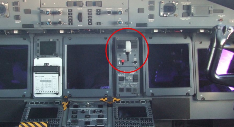 Cette photo du bureau d'enquête allemand montre la manette qui sert à relever le train d'atterrissage. Elle doit être actionnée simultanément avec le bouton rouge qui se trouve à côté.